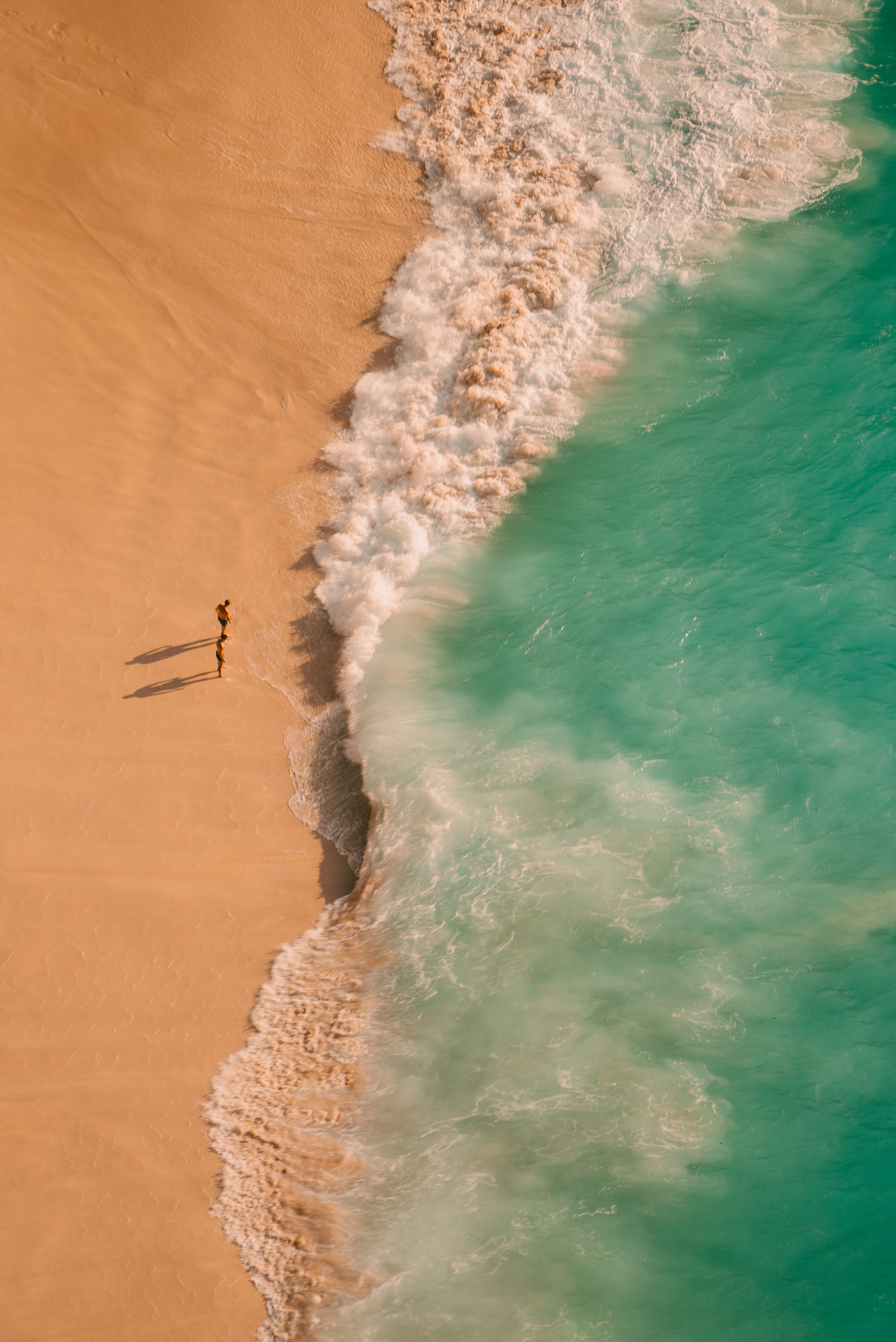 Aerial view of a Bali beach and turquoise shallow water