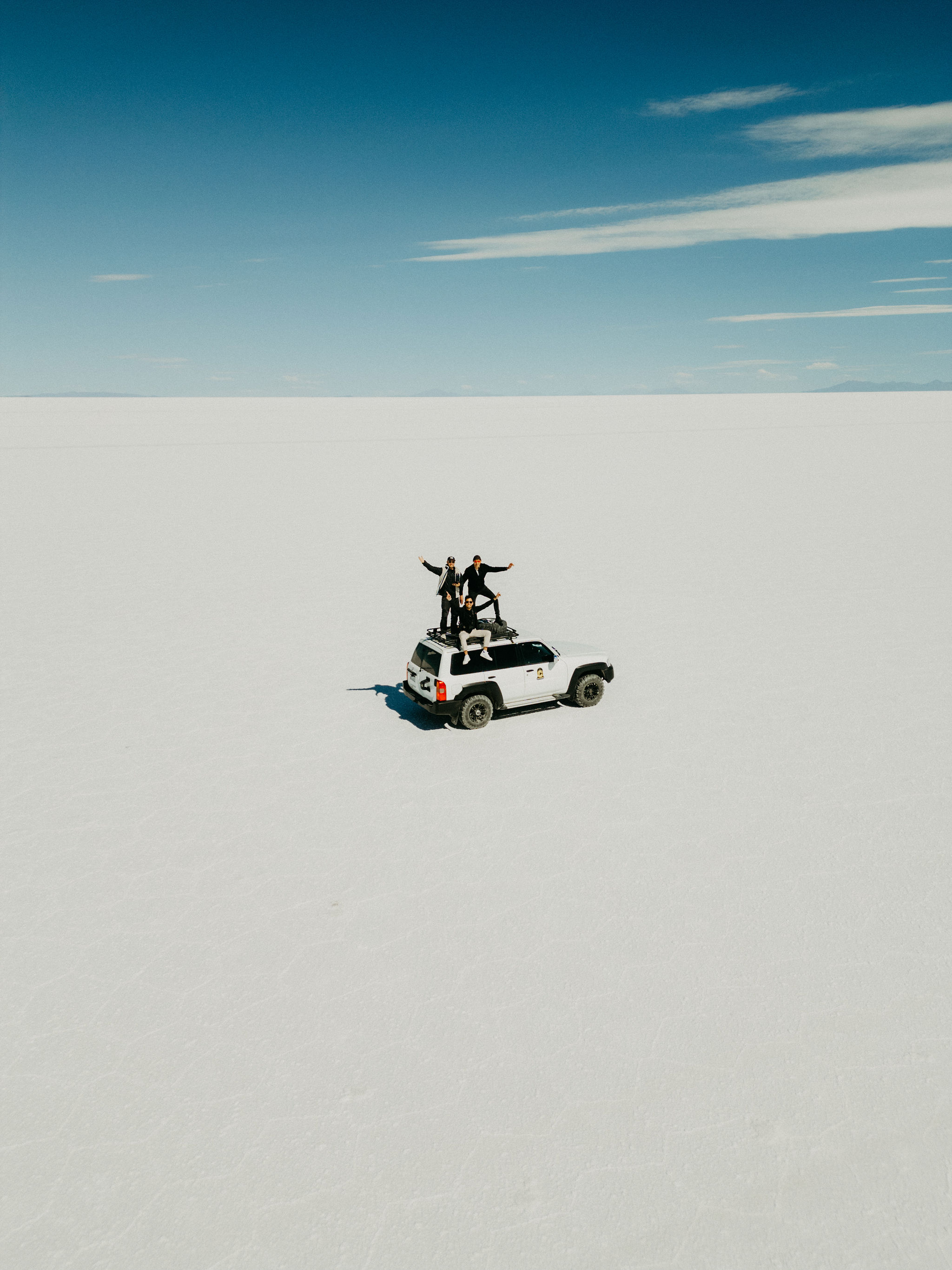 Travel group beside a 4x4 on the Bolivian Altiplano
