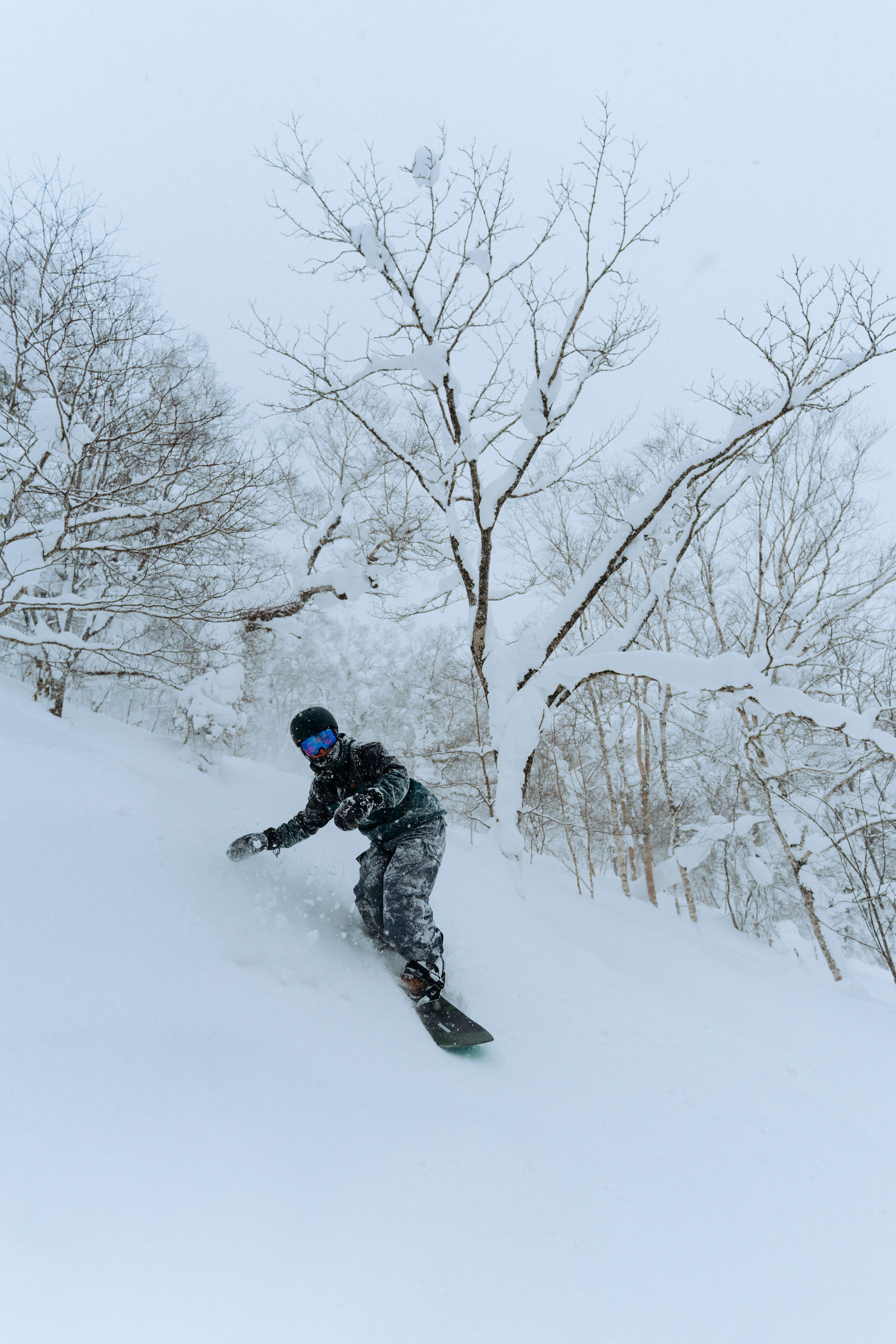 A group of riders on the chairlift above Niseko