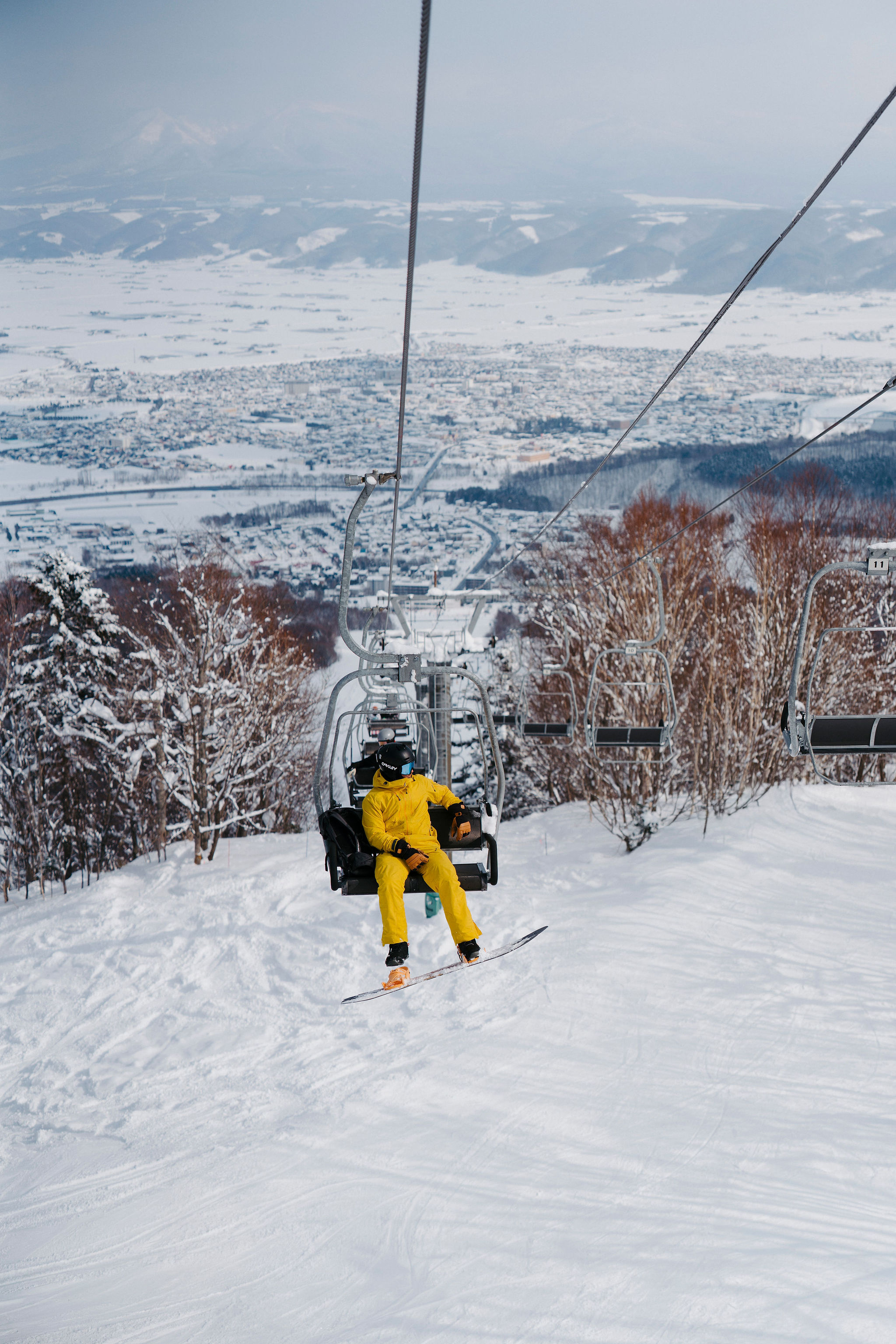 A chairlift crossing a snow-covered valley in Hokkaido