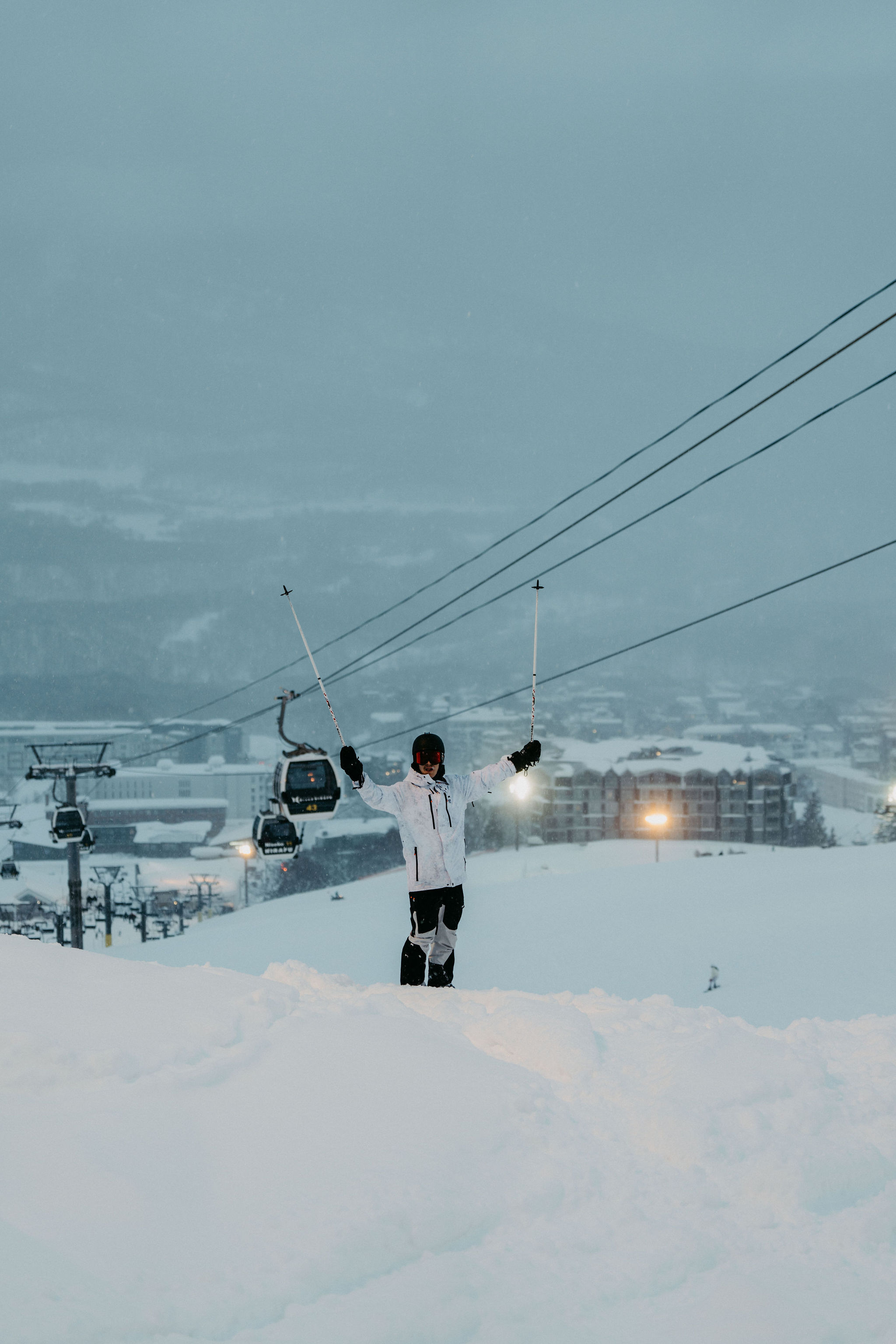 A snowboarder sinking into deep Niseko powder