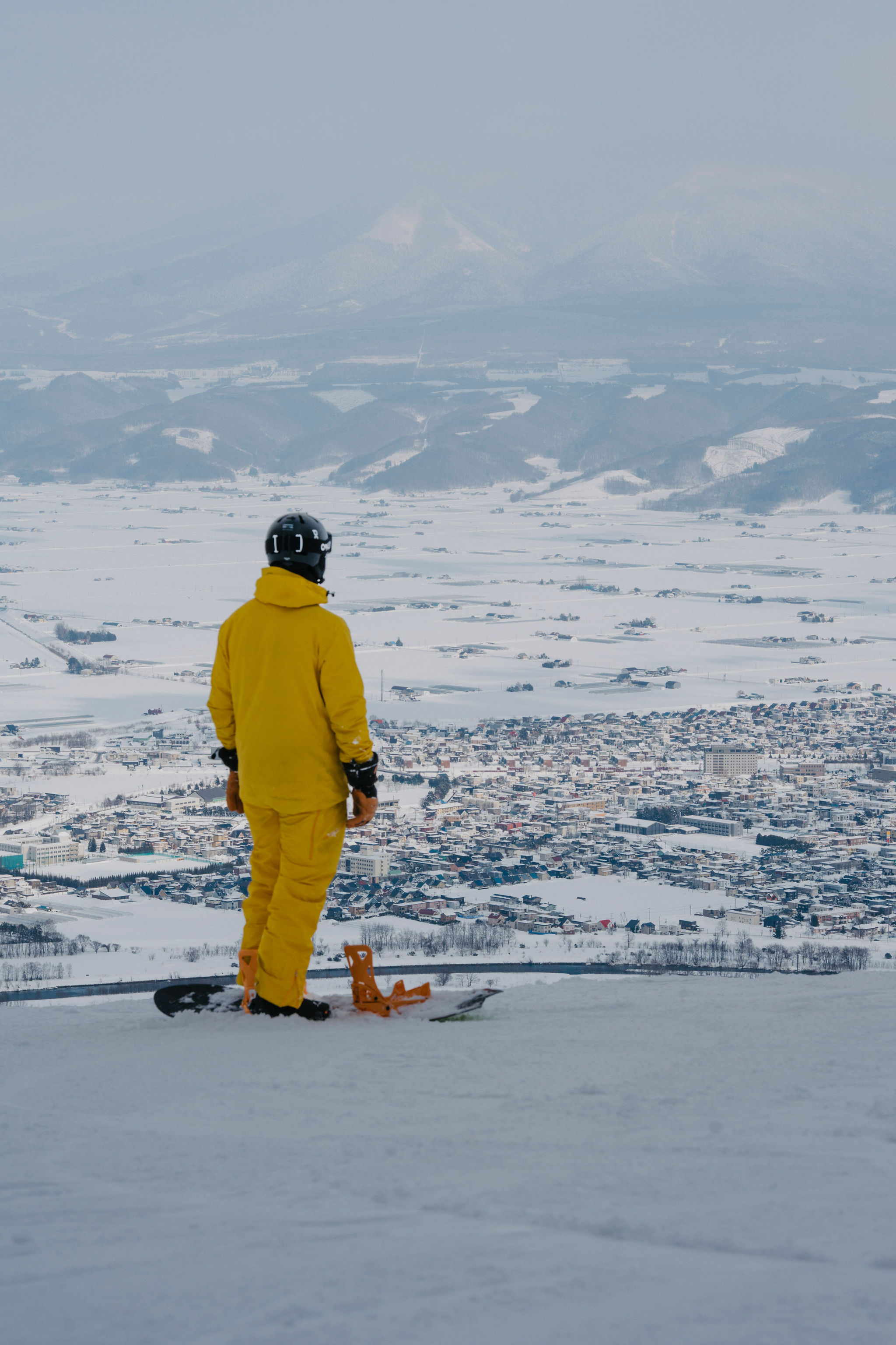 Rider looking out from a snowy summit in Hokkaido