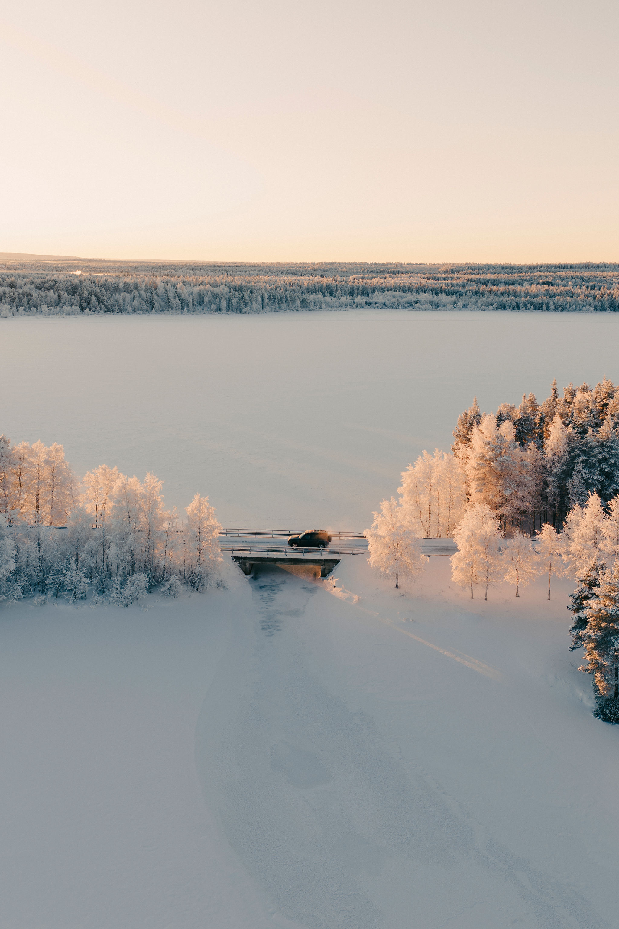 Frozen lake and bridge under the winter sky