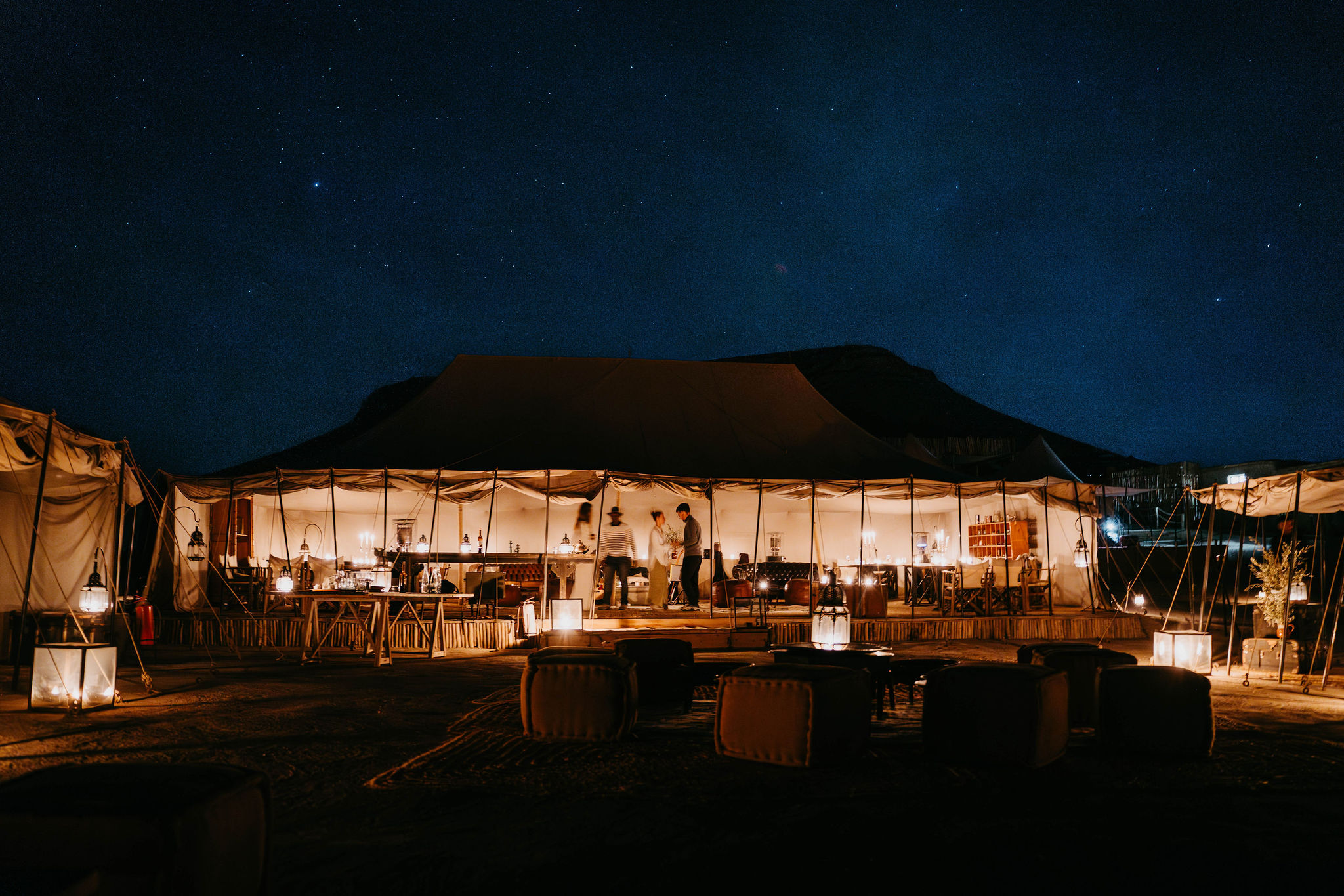 Dinner table set under the open sky at a desert camp