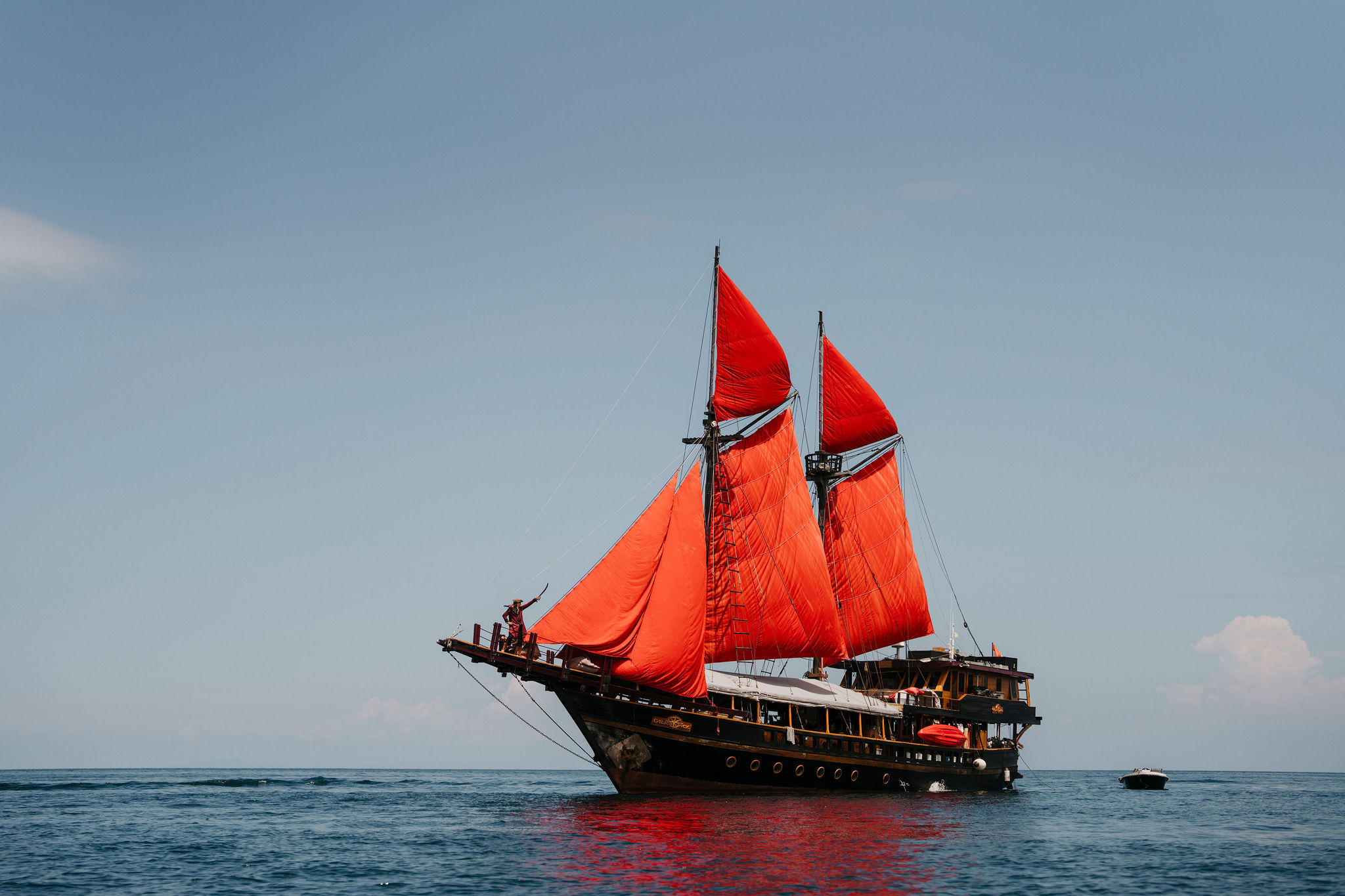 Traditional Phinisi liveaboard anchored between islands